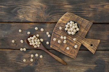 Wheat bran in a wooden bowl on a wooden table