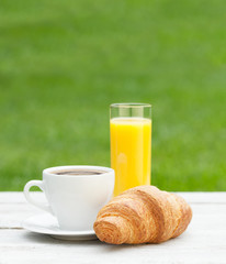 Coffee, orange juice and croissant