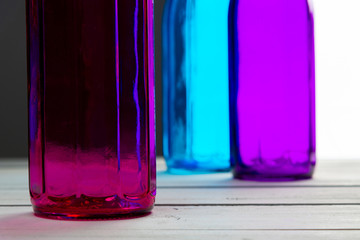Still life of three colored glass bottles