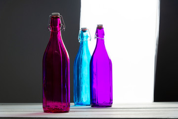 Still life of three colored glass bottles