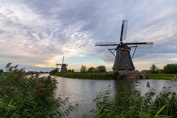 Dutch windmill reflected on the early sunset lights