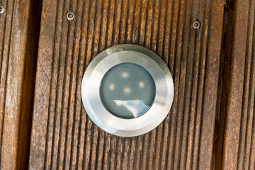 Installation of LED spotlights in a wooden terrace in the garden
