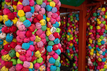Fototapeta na wymiar Kukurizaru - color balls, a monkey with bound feet and hands in Daikoku-san Kongō-ji Kōshin-dō temple. It help your wish become true