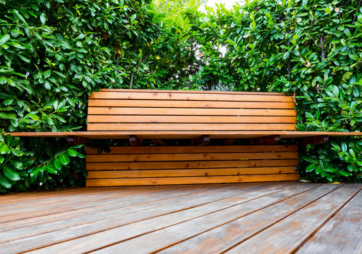 comfortable wooden bench in a corner of the garden