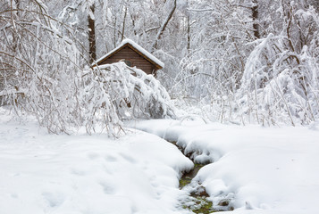 Winter landscape with a house and a river