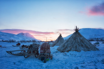 Nenets reindeer herders choom on a winter sunset