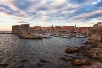 Fototapeta na wymiar Dubrovnik, a landscape overlooking the old town and large stones in the foreground, Croatia