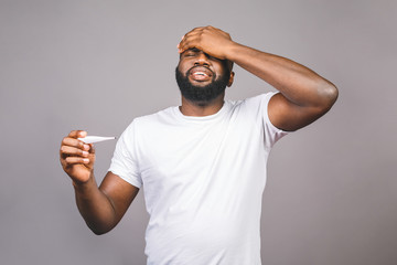 African american man standing over isolated grey background, illness and fever, flu and cold, virus...