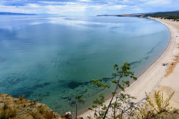Lake Baikal, trees and mountains of Siberia with beautiful sky and clouds, Russia Oklhon island