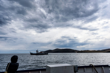 Irkutsk region, Russia - September 17, 2017: View from ferry which goes from Olkhon island to Sakhyurta village at mainland via lake Baikal. Ferry Semen Batagaev crossing Olkhon Gate or Olkhonskiye