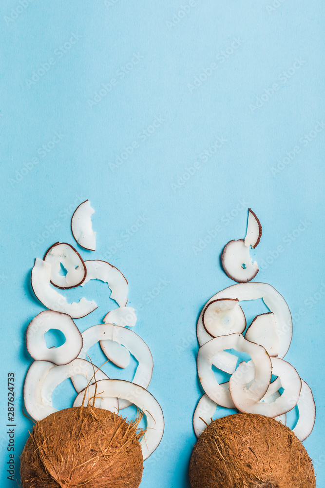 Wall mural Coconut chips in a bowl of coconut on a blue background