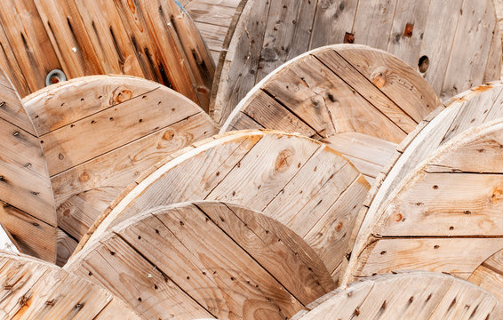 empty wooden cable drums stored beside construction site