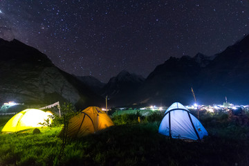 camping tent under milkyway with twinkling stars in the background - obrazy, fototapety, plakaty