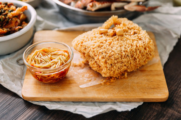 Crispy Fish with Green Mango Salad on wooden chopping board. Thai seafood.