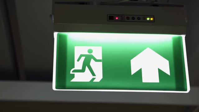 Emergency fire exit sign in doorway office building with siren alarm sound for evacuation people, escape plan guidance
