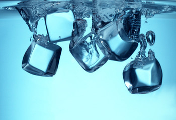 Group of ice cubes falling in water