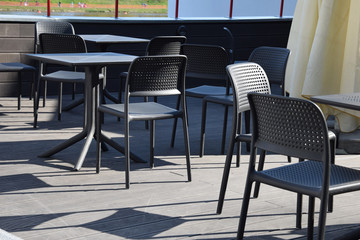 empty chairs and tables prepared for the season