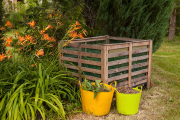 Compost bin and mulch in a summer garden