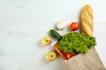 Bunch of mixed organic fruits, vegetables & greens, gourmet pile in full eco friendly shopping bag to reduce ecological footprint. Zero waste concept. White table background, copy space, close up.
