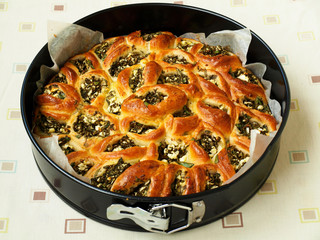Pie with feta and spinach in the form of separate pies after baking, horizontal orientation