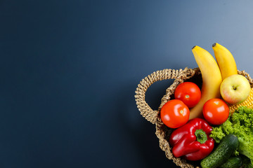 Bunch of mixed organic fruits, vegetables & greens, gourmet pile in full eco friendly shopping bag to reduce ecological footprint. Zero waste concept. Graphite table background, copy space, close up.