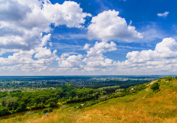 Obraz premium Rural landscape. Nature outdoor view on forest, river and town. Cloud sky scape.