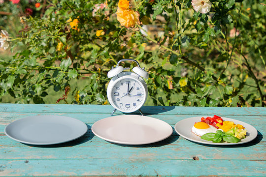 Intermittent fasting concept with empty colorful plates. Time to lose weight , eating control or time to diet concept.
