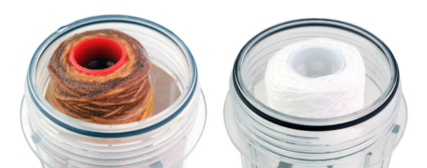 Filters in the flask for the purification of drinking water on a white background. Clean and dirty.