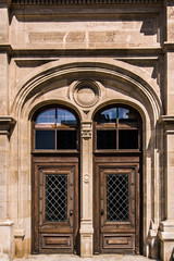 Naklejka premium Beautiful old wooden door with rivet ornaments in a medieval style