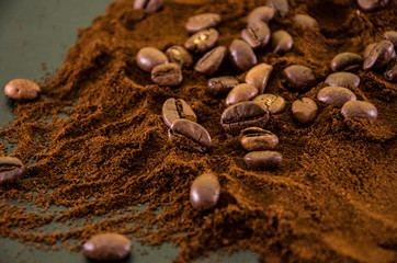 Fototapeta na wymiar Background of ground coffee and coffee beans. Top view.