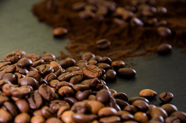 Heap of instant coffee with coffee beans on black.
