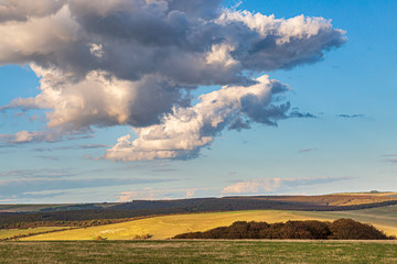 Obraz na płótnie Canvas Fluffy clouds over the South Downs in Sussex, on a sunny summers evening