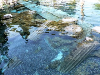 Underwater ancient pillars in Cleopatra's Antique Pool at the Pamukkale Hot Springs, Turkey.
