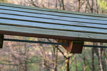 Fototapeta premium Fragment of a wooden structure fixed with a cable. Close-up.