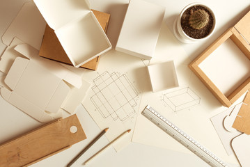 Workplace of the designer of cardboard packaging. Sketching paper boxes.  - 287634712