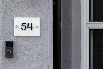 House number 54 with a digital doorbell