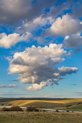 Fluffy clouds over the Cuckmere River in South Downs in Sussex, on a sunny summers evening