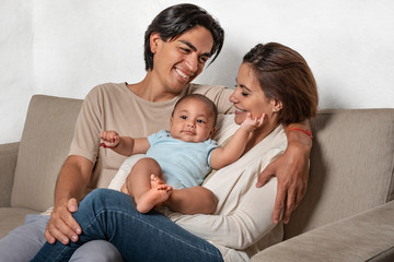 Young parents enjoying their newborn. Love and affection for their child