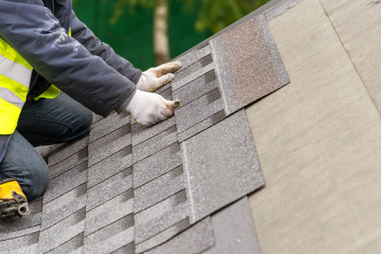 Workman Install Tile On Roof Of New House Under Construction