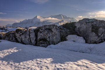 Snowy Oshten mountain peak on backgrgound at Lagonaki Highlands in West Caucasus. Scenic winter spring sunny day bluesky landscape