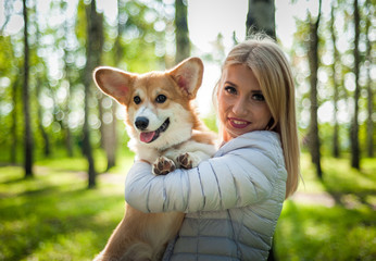 A young woman walks her dog in a summer Park