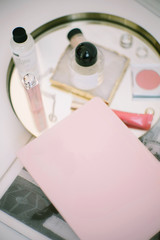 Cosmetics and notebook on a white table