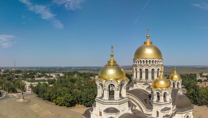 The Golden-domed Ascension Cathedral on Yermak Square in the provincial town of Novocherkassk in southern Russia. Luxurious aerial view on a sunny summer day mid-August.