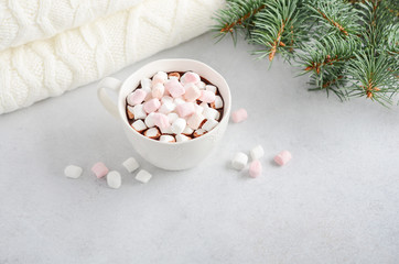 Cup of hot chocolate with marshmallows on a gray concrete background. 