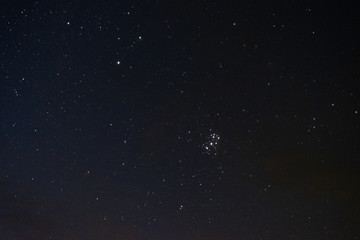 Stars in the night sky through the clouds