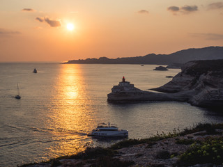 Naklejka na ściany i meble Lighthouse in Bonifacio at sunset ( Corsica - France)
