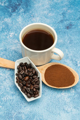 Roasted coffee beans, ground coffee, Cup of coffee, Wooden spoon with roasted coffee