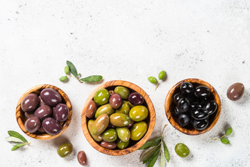 Black and green olives on white background.