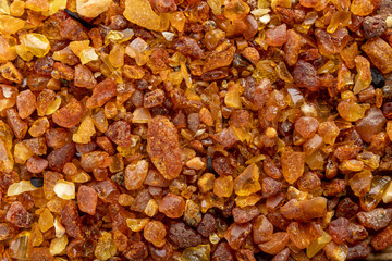 Small raw amber on a wooden table. A precious find from the coast of Central Europe.