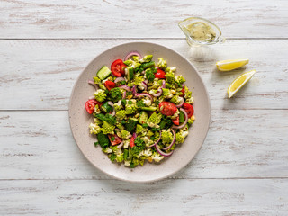 Vegetable salad with cabbage romanesco with olive oil. Top view.